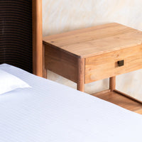 Close-up of natural wooden bedside table drawer and wood grain texture