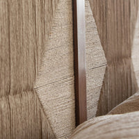 Close-up of handcrafted woven headboard with geometric textured design