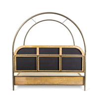 Back view of canopy bed with curved frame, wooden headboard and storage panel