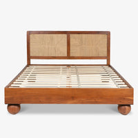 Wooden bed with woven headboard and slatted wooden platform base