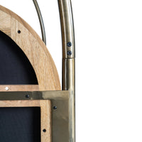 Close-up of curved metal canopy bed frame and wooden support joint