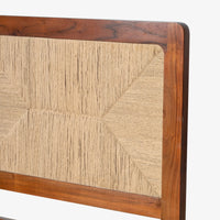 Close-up of textured woven headboard framed with natural wood