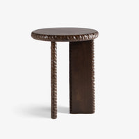 Nashi wooden accent side table side profile with round tabletop and detailed carved edges.