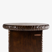 Nashi wooden accent side table side profile with round tabletop and detailed carved edges.