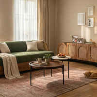 Round marble and wooden nesting coffee tables in a modern living room

