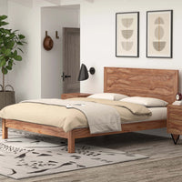 Natural wood bed styled in a modern bedroom with bedside table and bedding