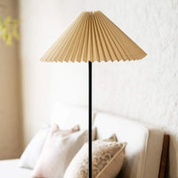 Cream pleated floor lamp beside a modern sofa in a cozy living room