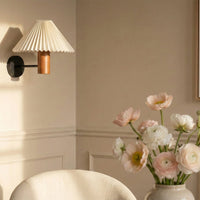 Cream pleated wall light illuminating a contemporary interior