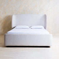 Front view of light grey fabric bed with upholstered headboard and minimalist design