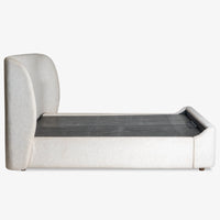 Side view of modern grey upholstered storage bed with wooden slat platform