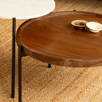 Close-up of marble and wooden coffee table tabletops with natural texture
