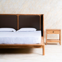 Wooden bed with dark brown textured headboard and matching wooden bedside table