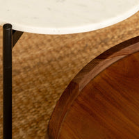
Round white marble coffee table with slim black metal legs