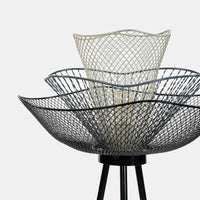 Close-up of layered wire basket shade on a modern floor lamp