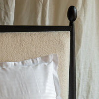 Close-up of modern king size bed frame and upholstered headboard