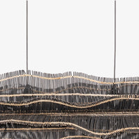 Close-up of woven black pendant chandelier with layered curved shades