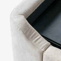 Close-up of grey upholstered bed frame corner and detailed fabric stitching