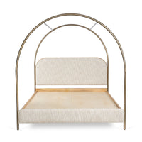 Front view of canopy bed with curved arched frame and upholstered headboard