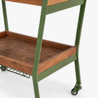 Close-up of wooden shelf and wheeled metal frame on serving trolley