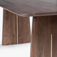 Close-up of dark walnut wooden dining table corner and pedestal legs
