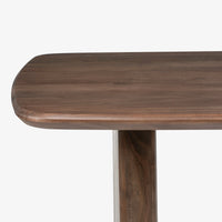 Close-up of rounded wooden dining table edge and natural wood grain