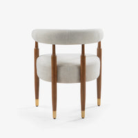 Close-up of cream upholstered armchair seat and wooden legs