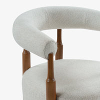 Close-up of curved cream fabric backrest and wooden chair frame