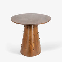 Round wooden dining table side view with sculptural pedestal base