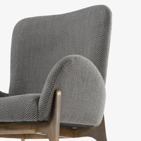 Close-up of grey upholstered chair backrest and wooden frame