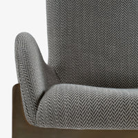 Close-up of grey dining chair seat, backrest and curved armrest