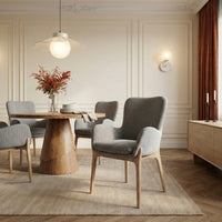 Grey upholstered dining chairs around a wooden dining table in a contemporary interior