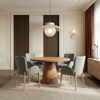 Wooden pedestal dining table with upholstered chairs in contemporary interior