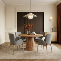 Round wooden dining table with natural wood finish in elegant dining room