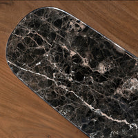 Close-up of black marble inlay with white natural veining on wooden table
