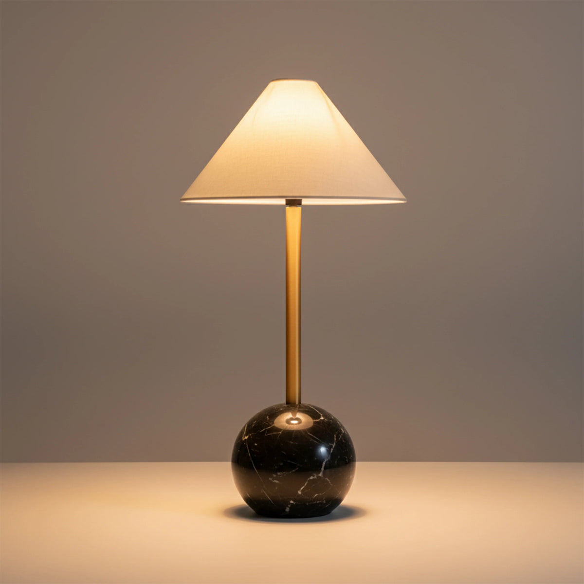 Modern black spherical base table lamp with cream fabric shade